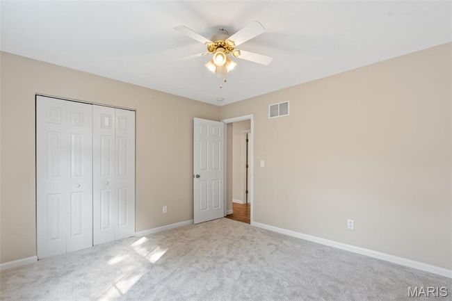 Unfurnished bedroom with carpet flooring, baseboards, a closet, and a ceiling fan | Image 21