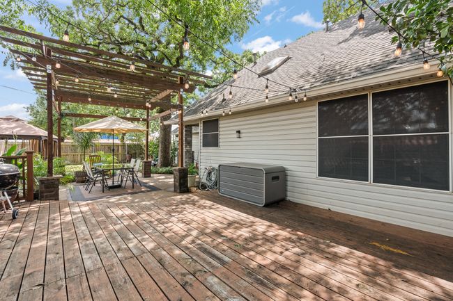 Wooden terrace featuring a pergola, a fenced backyard, and outdoor dining space | Image 26