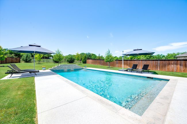 View of pool featuring a yard, a fenced backyard, and a patio area | Image 31