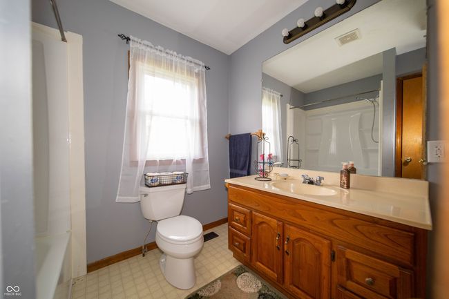 full bathroom with tile patterned floors, vanity, toilet, and baseboards | Image 25