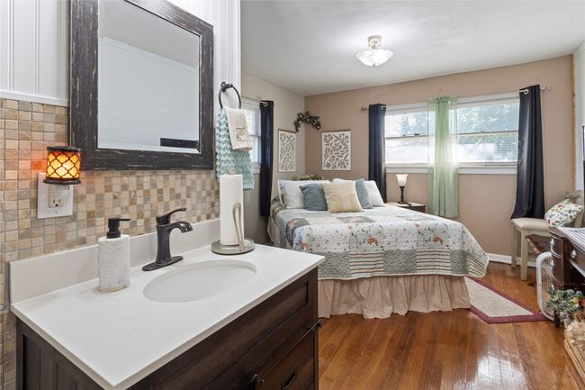 Bedroom featuring a sink and wood finished floors | Image 15