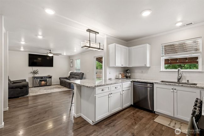 Kitchen open to family room and dining area. Bright and airy kitchen overlooking the backyard. | Image 9