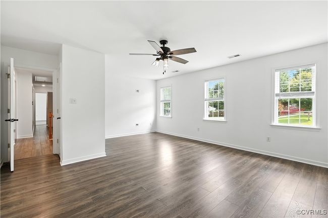 Primary bedroom with a ceiling fan and Laminate Style Flooring & Walkin Closet. | Image 16