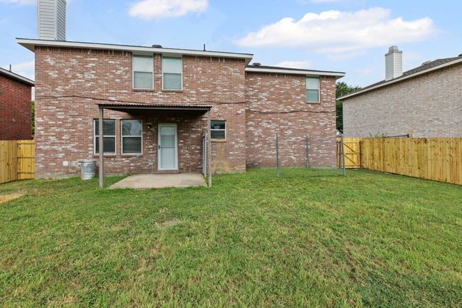 Back of house with a fenced backyard, a patio, and brick siding | Image 24