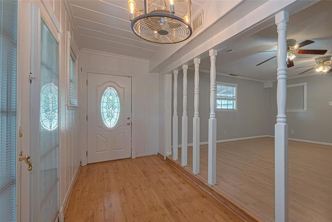 Classic country style in the entree way through the double glass doors with dustless blinds and wood floors. | Image 9