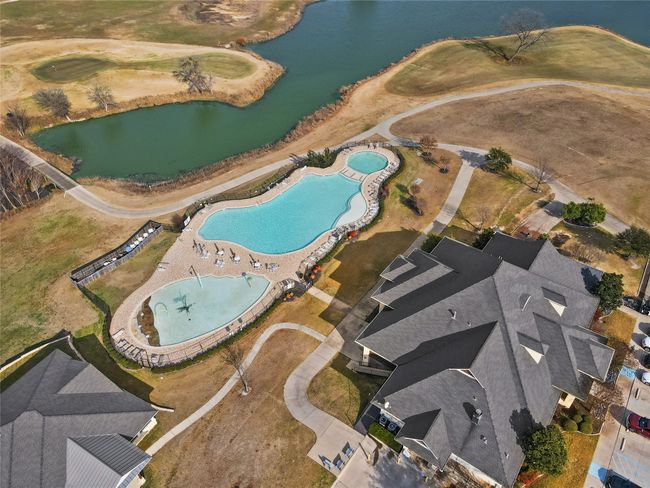 Aerial view of property's location featuring a pool area and a nearby body of water | Image 8