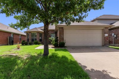 Single story home with a garage and a front yard | Image 2