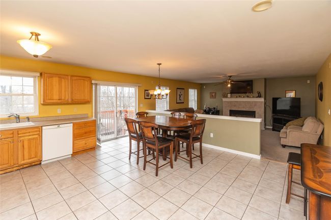 Dining area with a wealth of natural light, a fireplace, and light tile patterned flooring | Image 18