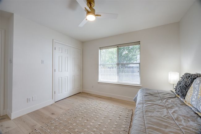 Bedroom featuring light wood-type flooring, ceiling fan, and a closet | Image 26