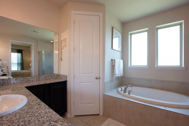 Full bathroom featuring tile patterned flooring, a shower stall, a garden tub, and a wealth of natural light | Image 20