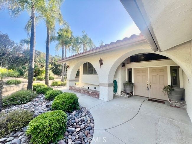 Front of house walking through gate | Image 9