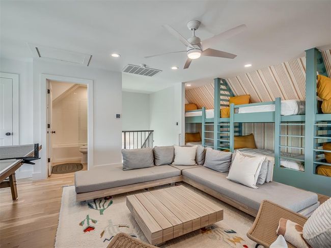 Living area featuring light wood-type flooring, attic access, ceiling fan, recessed lighting, and baseboards | Image 33
