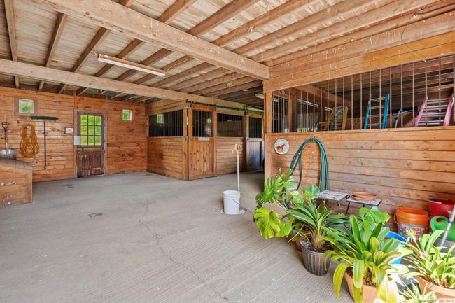 Beautiful stalls, electric hook ups, and room for hay storage. | Image 37