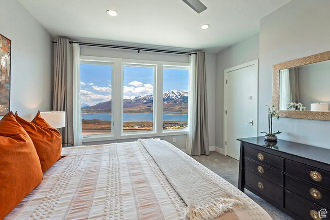 Bedroom with baseboards, recessed lighting, a water view, and light colored carpet | Image 16