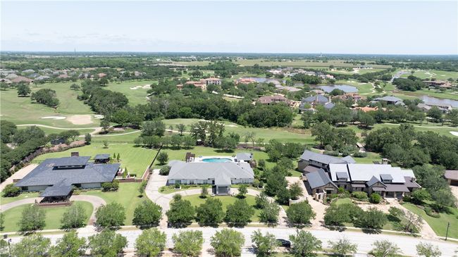 Aerial perspective of suburban area featuring a local golf course and a nearby body of water | Image 27