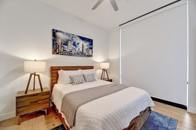 Bedroom featuring wood finished floors, baseboards, and ceiling fan | Image 9