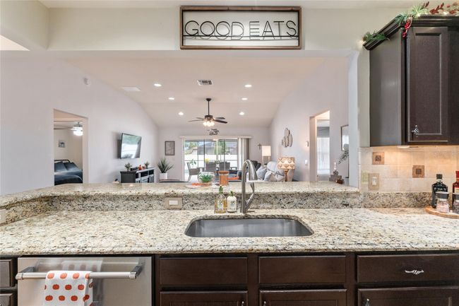 Kitchen counter open to living area and rest of home allowing for ease of entertaining or every day living | Image 8