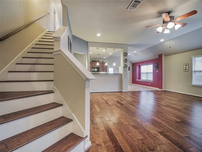 Staircase featuring wood finished floors, ceiling fan, and baseboards | Image 31