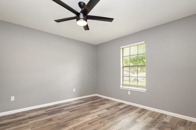 Unfurnished room with wood finished floors, a ceiling fan, and baseboards | Image 28