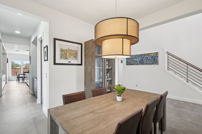Dining room with recessed lighting and concrete floors | Image 7