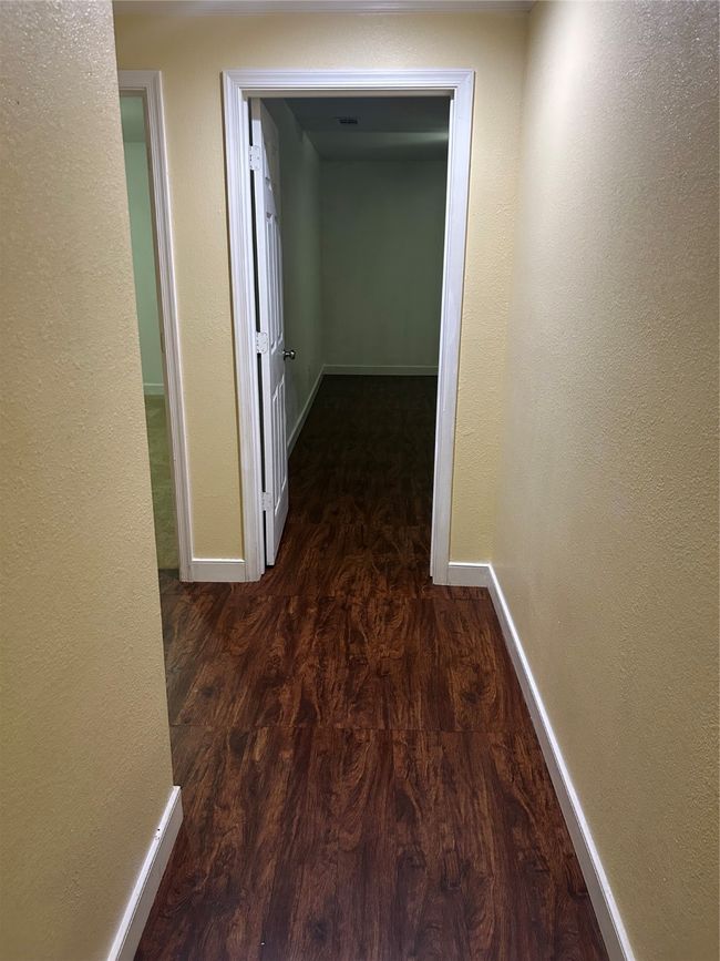 Corridor featuring a textured wall and wood finished floors | Image 13
