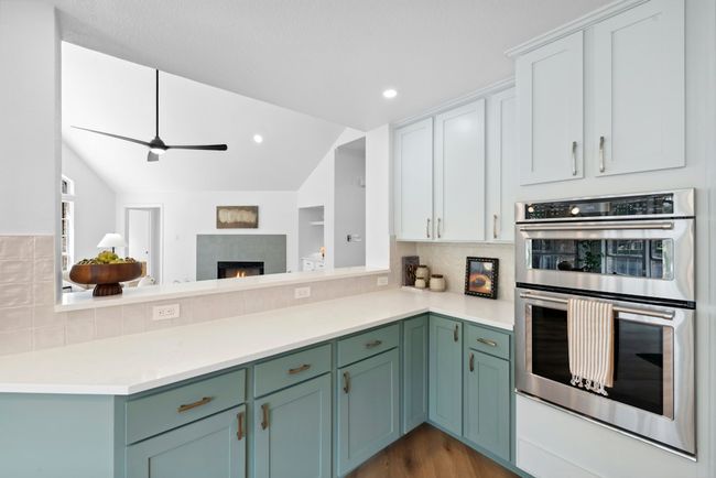 Kitchen overlooks the living room and has plenty of cabinet space and a large pantry | Image 8