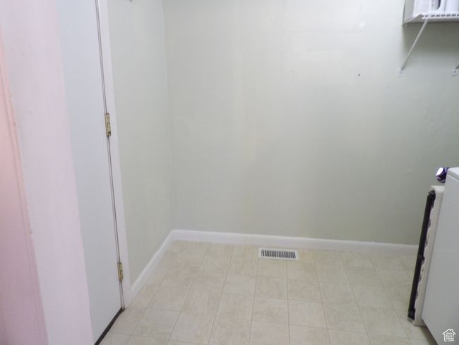 Clothes washing area with light tile flooring | Image 35