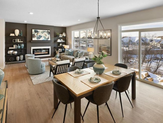 Designed for modern living, the open-concept main floor seamlessly blends the dining room with the kitchen and great room. This spacious layout creates an inviting atmosphere, perfect for entertaining or everyday family gatherings. | Image 12