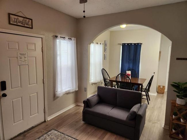 Cozy and inviting living room in a charming one-bedroom unit, featuring a warm ambiance and open layout. | Image 19