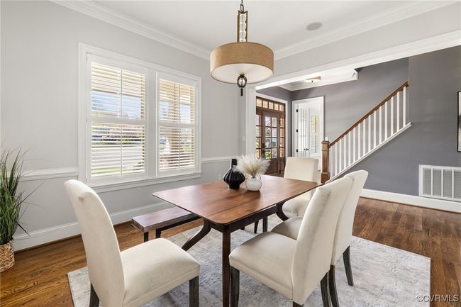 10' ceilings, 8' open casement; chair rail, designer light fixture, plantation shutters, site finished hardwood floors | Image 8