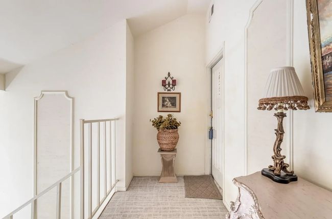 Hallway featuring lofted ceiling | Image 14