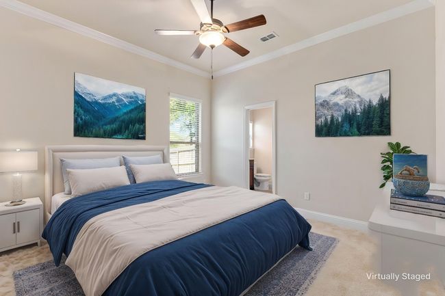 Bedroom featuring light carpet, ornamental molding, connected bathroom, baseboards, and ceiling fan | Image 8