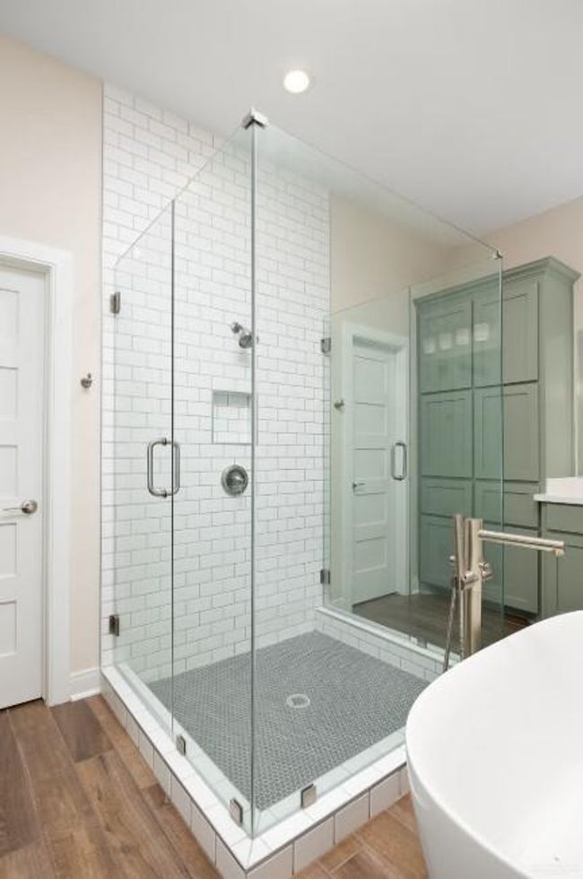 Full bathroom with recessed lighting, a soaking tub, a stall shower, and wood finished floors | Image 21
