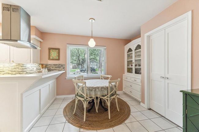 Delightful breakfast nook with a classic built-in buffet and elegant pendant lighting. | Image 12