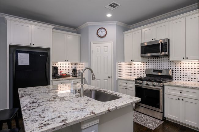 Featuring hardwood floors, stainless steel appliances, a center island with sink, walk-in pantry | Image 5