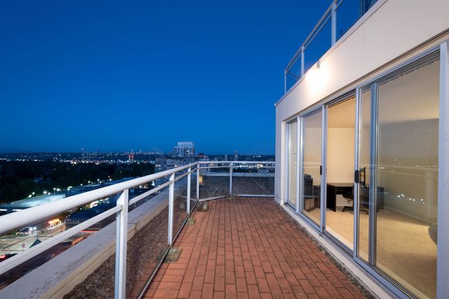 Balcony at twilight featuring a view of city lights | Image 28