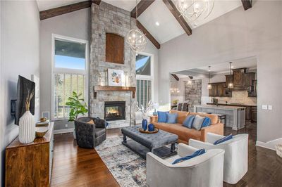 Impressive great room with stone see-through fireplace, and vaulted/beamed ceiling. | Image 2