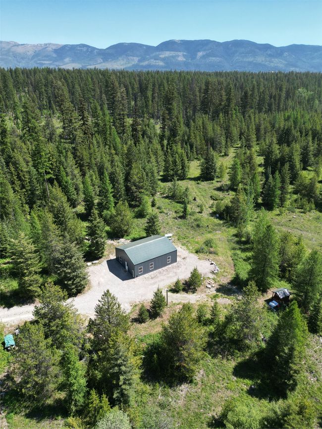 View of subject property with a forest and a mountainous background | Image 25