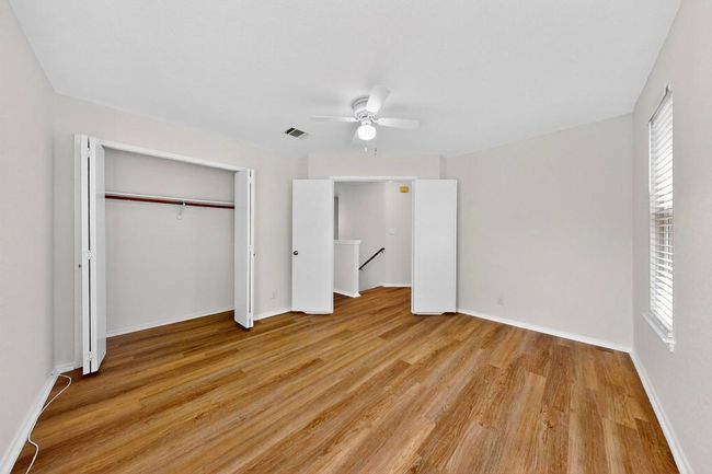 Unfurnished bedroom with light wood finished floors, multiple windows, and a closet | Image 21