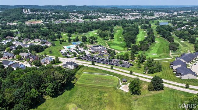 Aerial view of property and surrounding area with a golf club and a tree filled landscape | Image 59