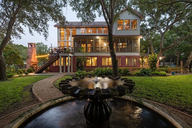 The residence is thoughtfully divided into two separate homes, each with its own unique character. The first floor encompasses two bedrooms, a full bathroom, a well-appointed kitchen, a welcoming dining area, and the added convenience of two distinct living spaces. Ascending to the second and third floors reveals another facet of this property's versatility, with two to three bedrooms, two full bathrooms, two dedicated office spaces, a kitchen, grand main living space and covered and open patios. | Image 12