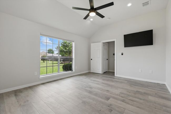 Spare room with a ceiling fan, lofted ceiling, recessed lighting, baseboards, and light wood-style floors | Image 20