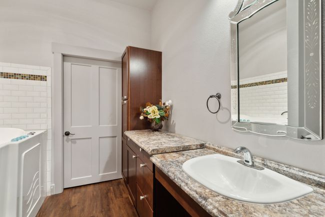 Bathroom with a tub, wood-type flooring, and vanity | Image 15