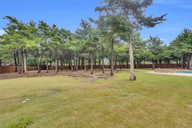 Fenced backyard featuring view of wooded area | Image 36