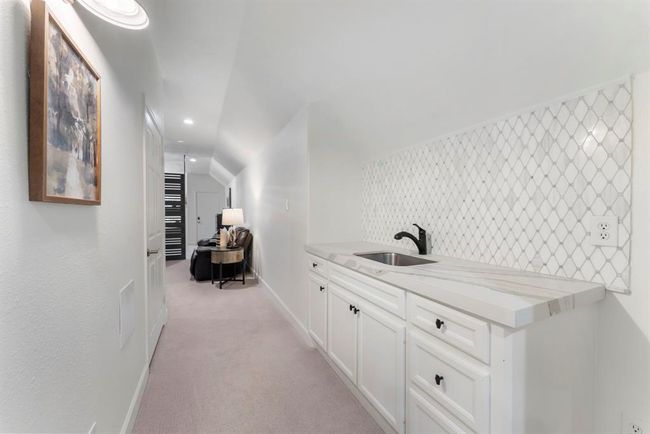 Walking into the media and game room with a wet bar. | Image 32