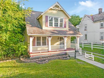 View of front of home featuring a front lawn and a porch | Image 1