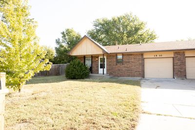 Single story home featuring a front lawn and a garage | Image 2