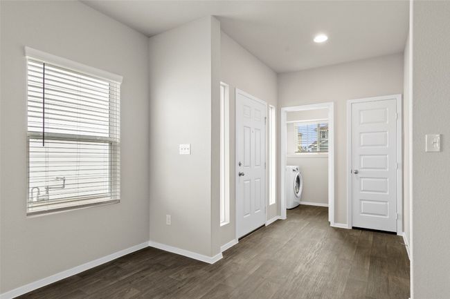 Unfurnished bedroom with dark wood-style flooring, baseboards, washer / dryer, and recessed lighting | Image 13