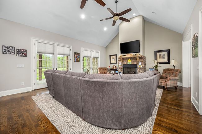 Large windows fill the space with natural light, enhancing the room's welcoming ambiance and making it the perfect place for relaxation and socializing | Image 36