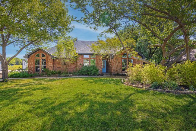 View of front of house featuring roof with shingles, brick siding, and a front lawn | Image 31
